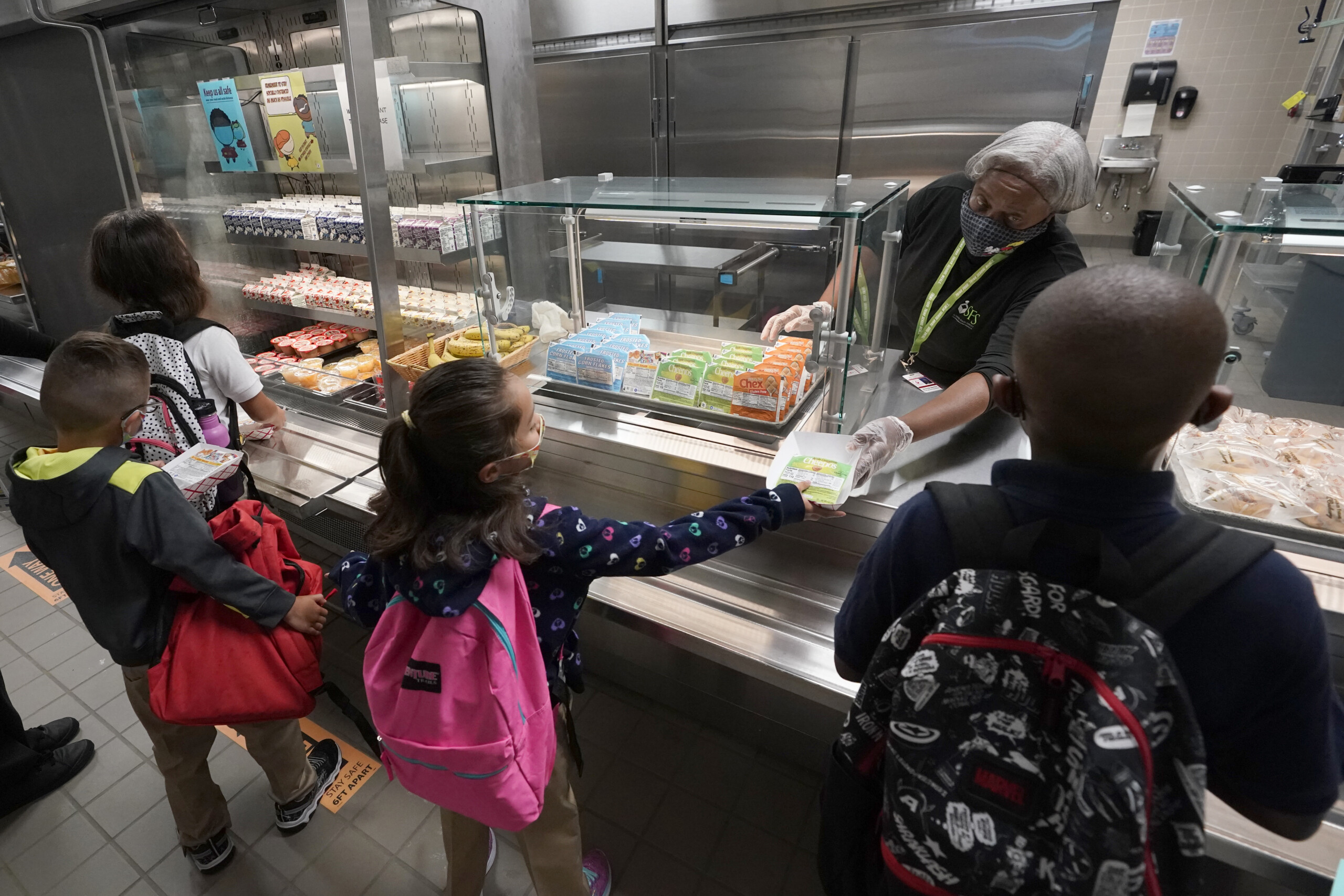 Food service assistant Brenda Bartee gives students breakfast at Washington Elementary School in Riviera Beach in August 2021. | Wilfredo Lee, AP
