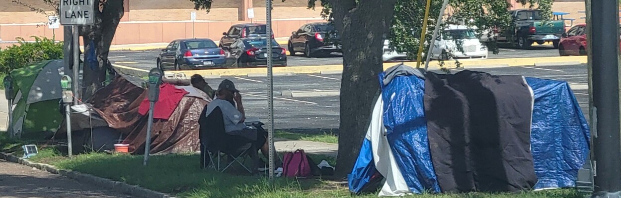 Homeless people sit outside tents on East Adams Street in Downtown Jacksonville, near North Liberty Street. | Dan Scanlan, Jacksonville Today