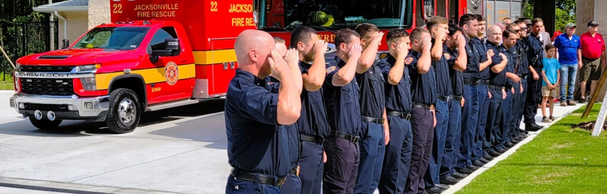 Fire Station 22 firefighters salute as the station's flag is raised for the first time on Wednesday, July 31, 2024. | Dan Scanlan, Jacksonville Today