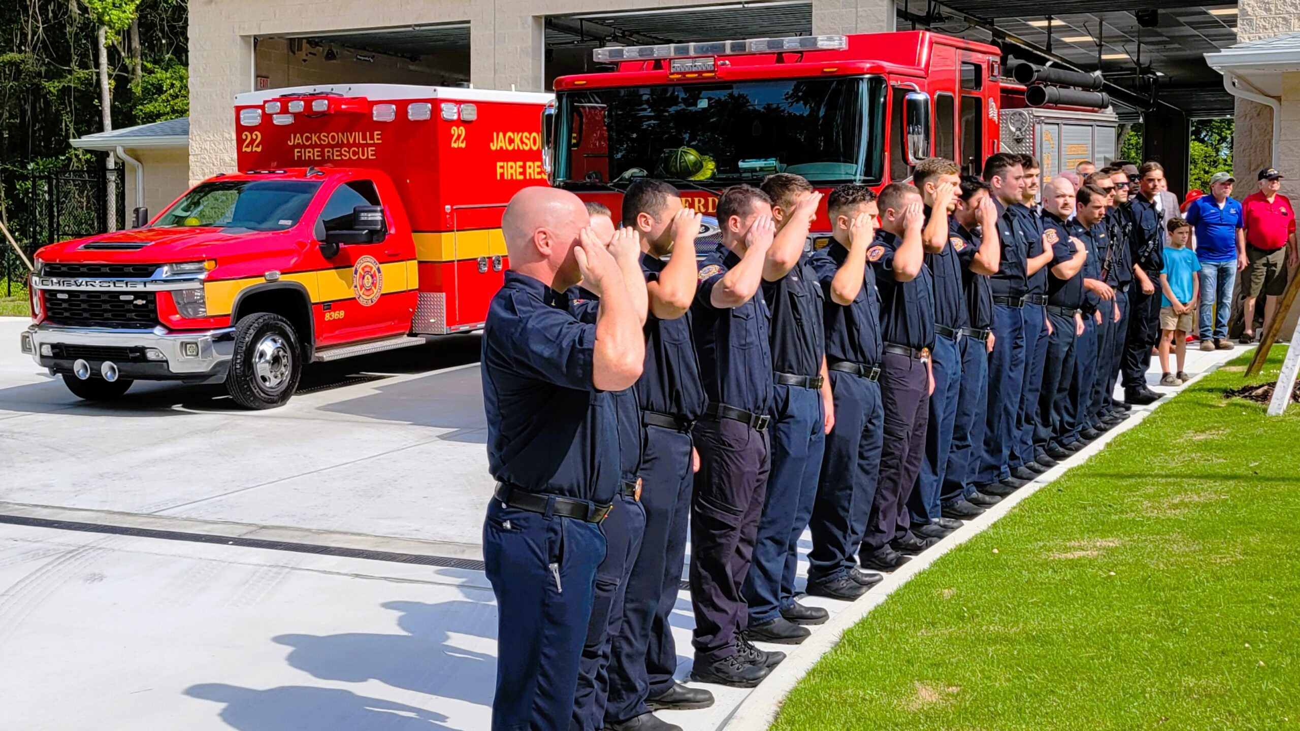 Fire Station 22 firefighters salute as the station's flag is raised for the first time on Wednesday, July 31, 2024. | Dan Scanlan, Jacksonville Today