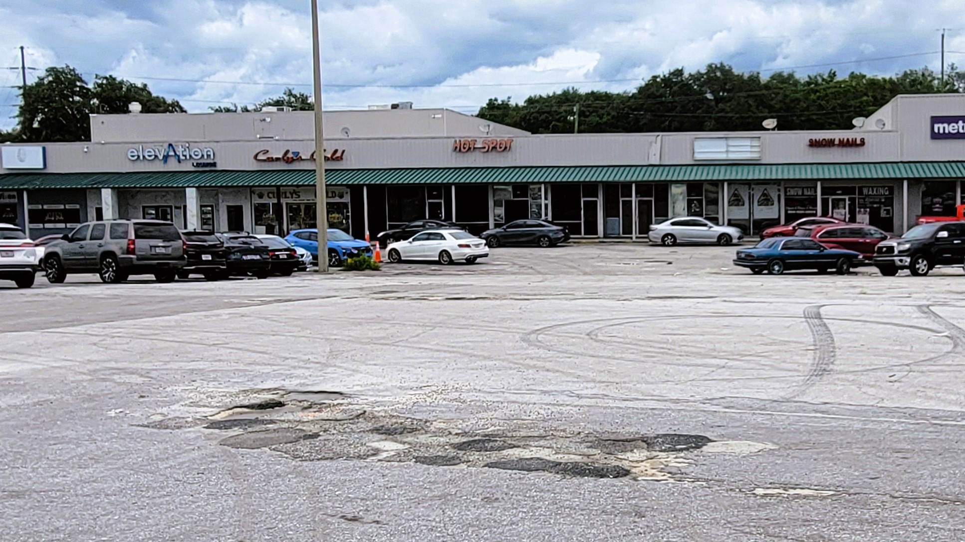 Dozens of potholes pockmark the Norwood Plaza parking lot. | Dan Scanlan, Jacksonville Today