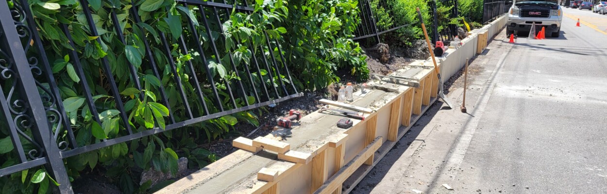 A new support wall was being laid Friday, Aug. 23, 2024, at Memorial Park. The metal fence damaged in a vehicle crash remained to be fixed. | Dan Scanlan, Jacksonville Today