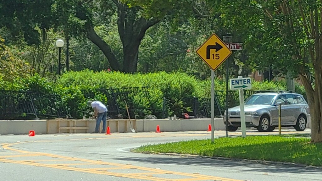 Work continues to repair a fence and wall damaged on the Riverside Avenue edge of Memorial Park after a car crashed into it. | Dan Scanlan, Jacksonville Today