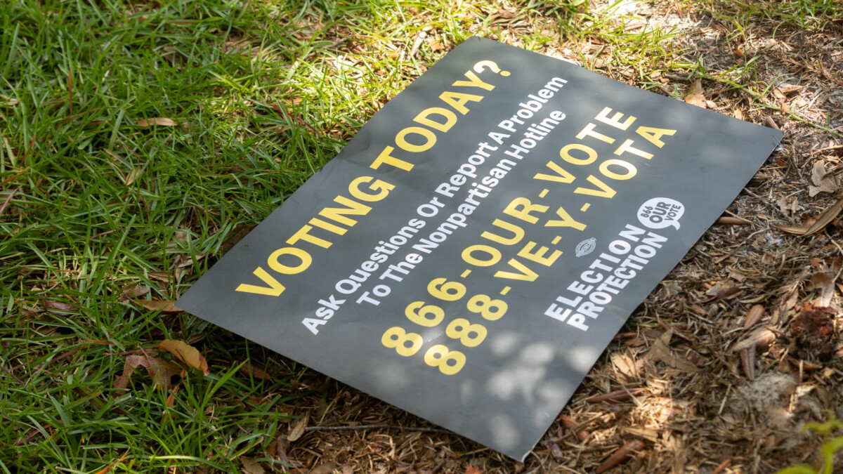 A sign at the Legends Center in Northwest Jacksonville advises people how to report problems on Election Day, Tuesday, Aug. 20, 2024. | Will Brown, Jacksonville Today