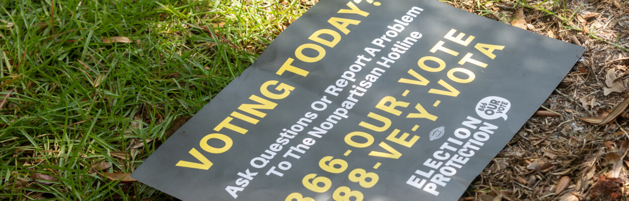 A sign at the Legends Center in Northwest Jacksonville advises people how to report problems on Election Day, Tuesday, Aug. 20, 2024. | Will Brown, Jacksonville Today