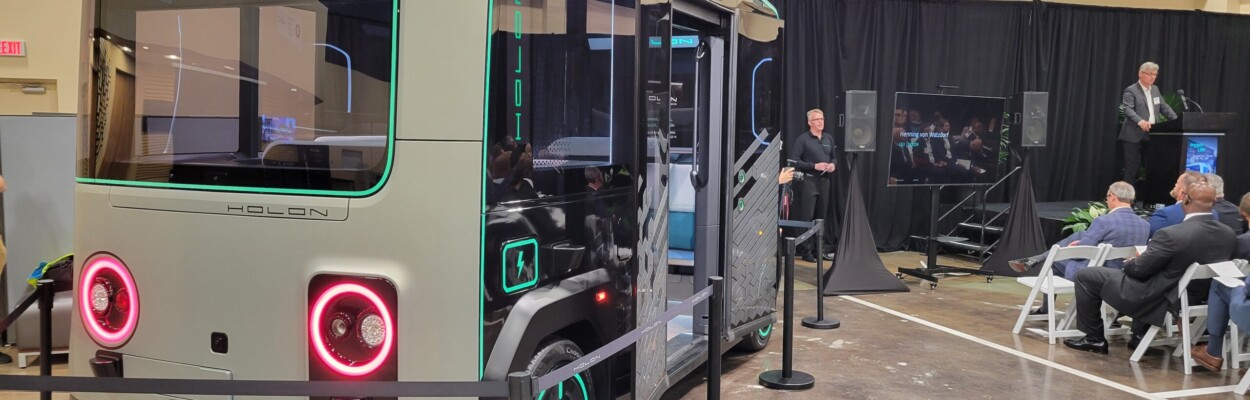 Henning von Watzdorf, CEO of Holon, announces plans for an autonomous vehicle plant on Jacksonville's Northside. The Holon autonomous vehicle is shown on the left. | Dan Scanlan, Jacksonville Today