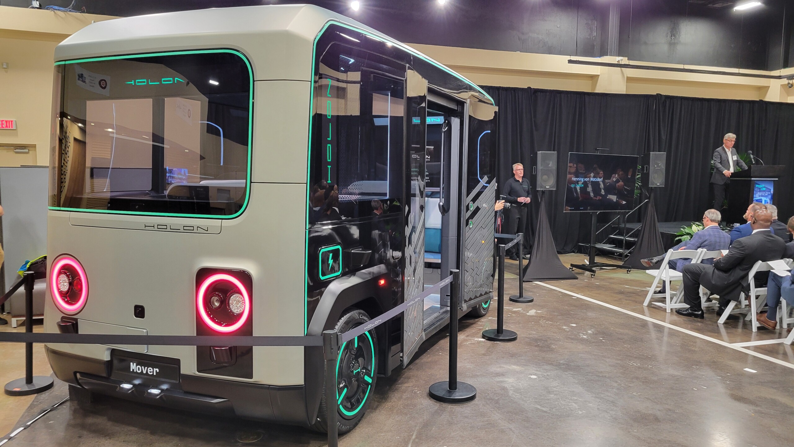 Henning von Watzdorf, CEO of Holon, announces plans for an autonomous vehicle plant on Jacksonville's Northside. The Holon autonomous vehicle is shown on the left. | Dan Scanlan, Jacksonville Today