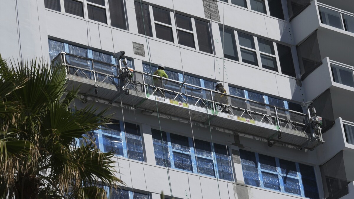 Workers repairing condo