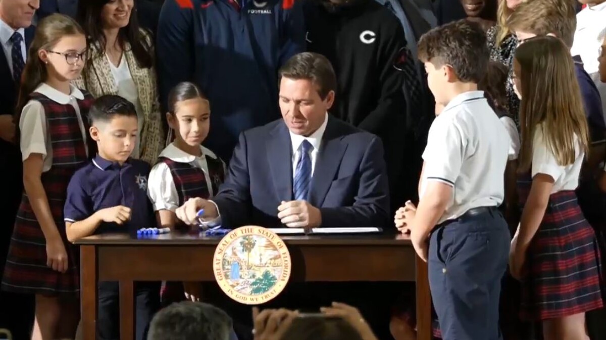 Gov. Ron DeSantis signs the school voucher bill.