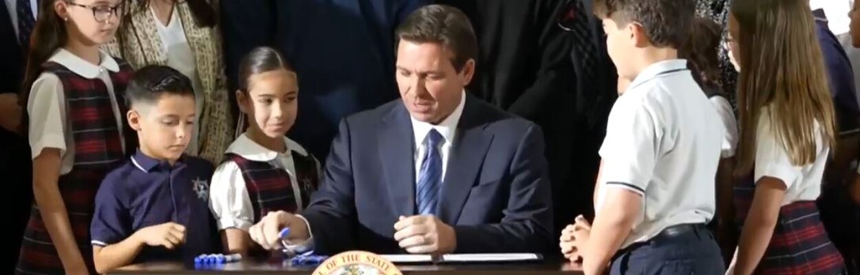 Gov. Ron DeSantis signs the school voucher bill.