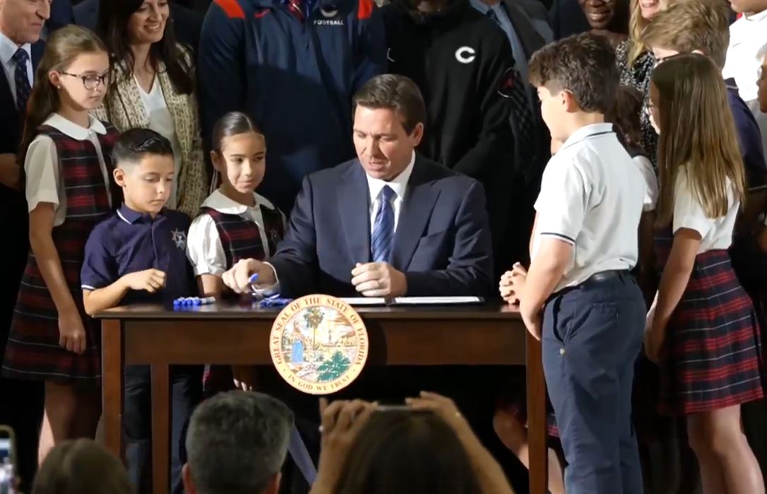 Gov. Ron DeSantis signs the school voucher bill.