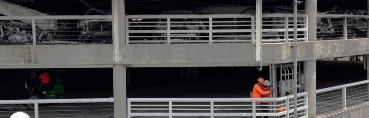 Workers in burned parking garage
