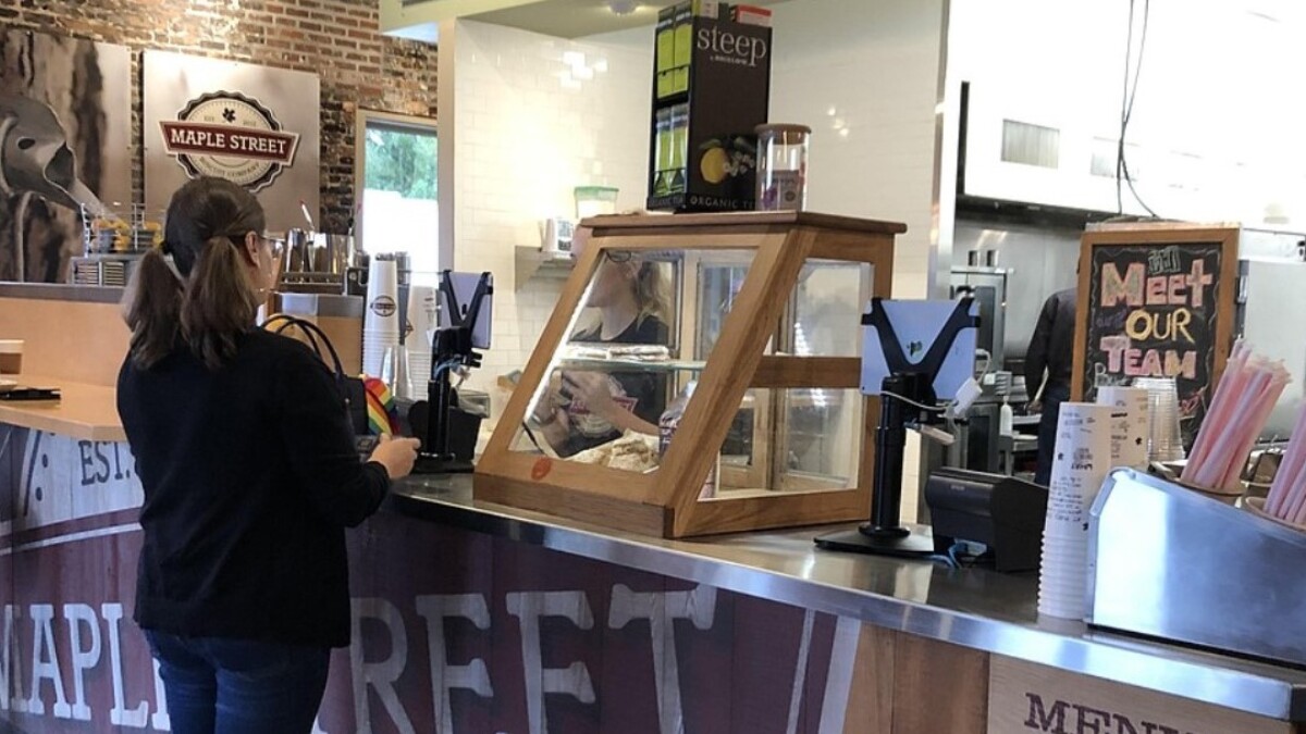 A customer stands at the counter at Maple Street Biscuit Co.