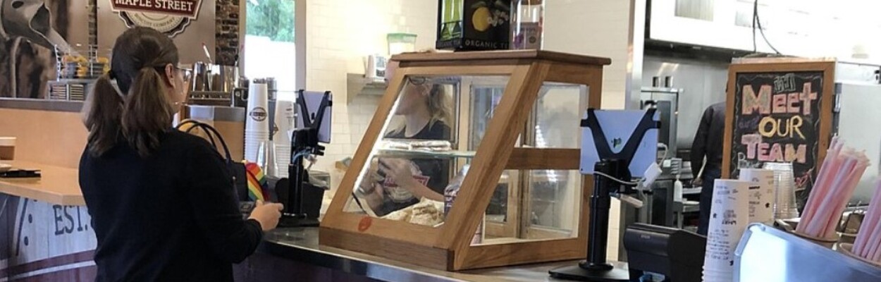 A customer stands at the counter at Maple Street Biscuit Co.