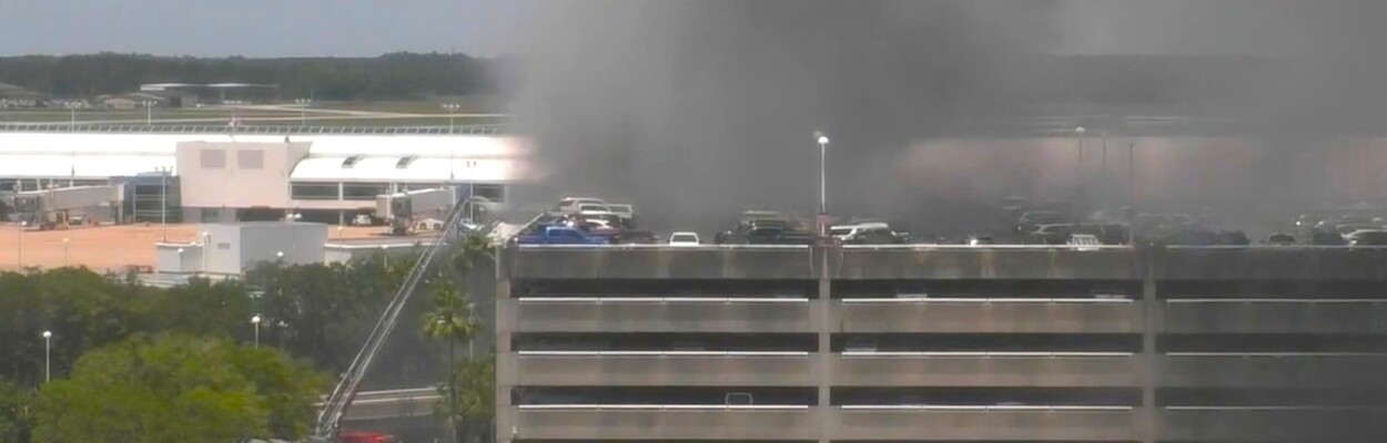 Smoke billows from the airport parking garage