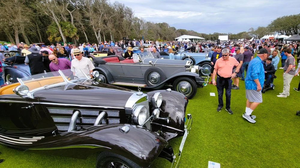 Crowds look at the classic cars at The Amelia