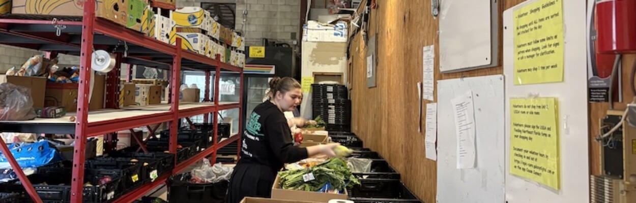 Worker sorting produce at Epicure