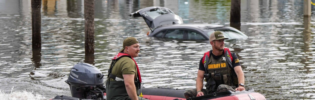 Two rescuers in a boat after Hurricane Milton
