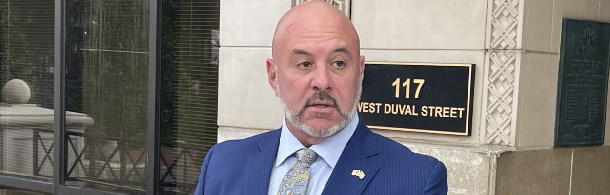 Florida Chief Financial Officer Blaise Ingoglia talks into a microphone at Jacksonville City Hall.