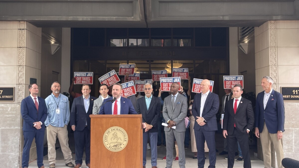 Jacksonville City Council President Kevin Carrico speaks surrounded by other members.