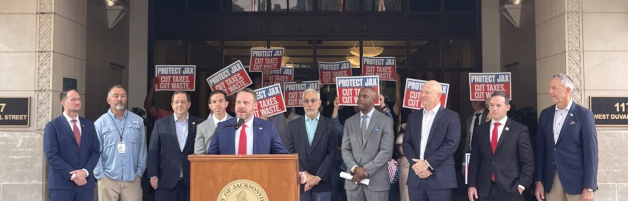 Jacksonville City Council President Kevin Carrico speaks surrounded by other members.