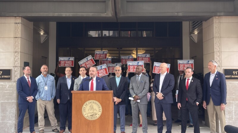 Jacksonville City Council President Kevin Carrico speaks surrounded by other members.