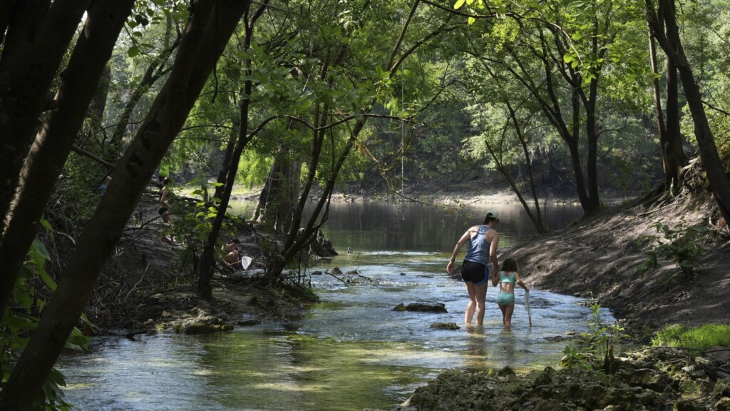 Mother and daughter walking along Royal Spring in Suwannee County