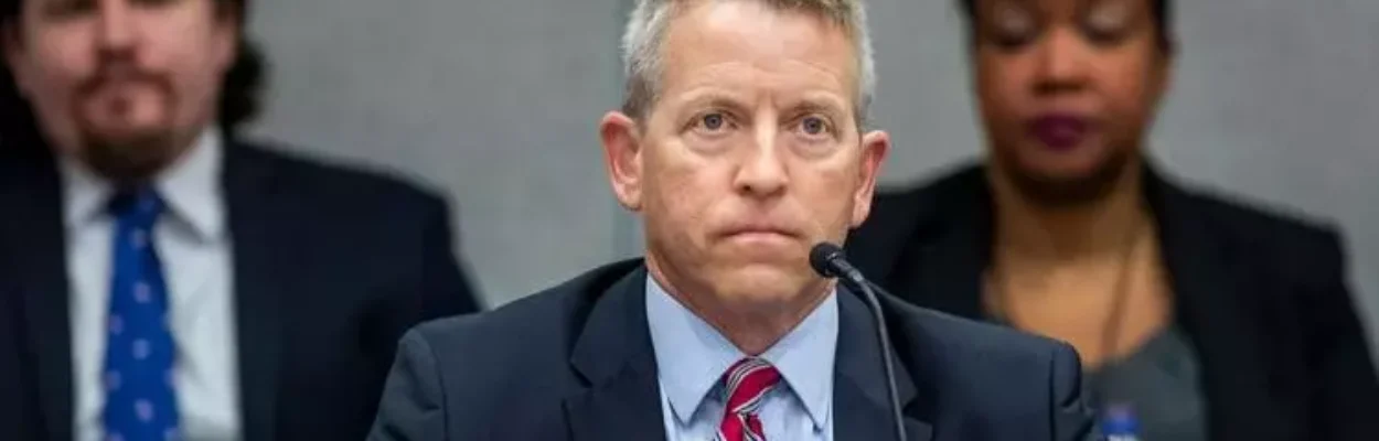 Paul Renner sits behind microphone