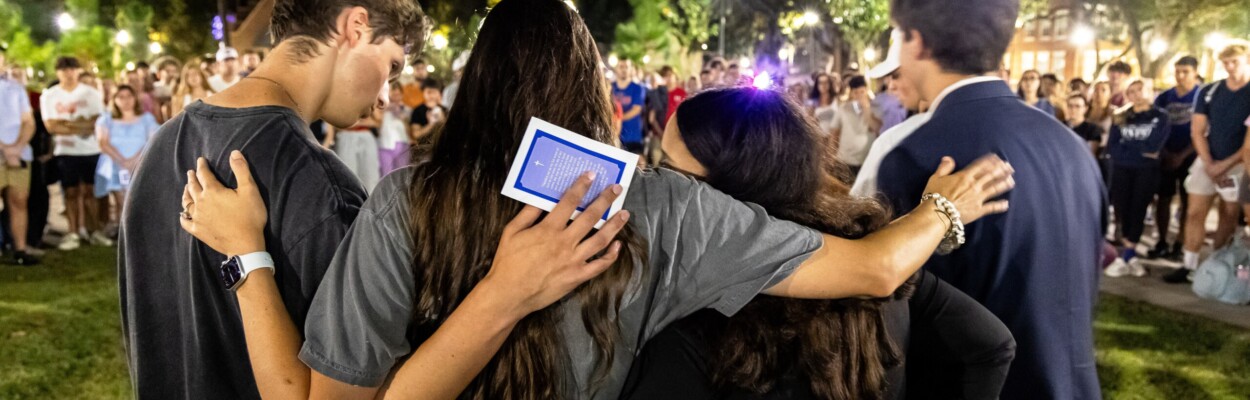 People embrace at vigil for Charlie Kirk