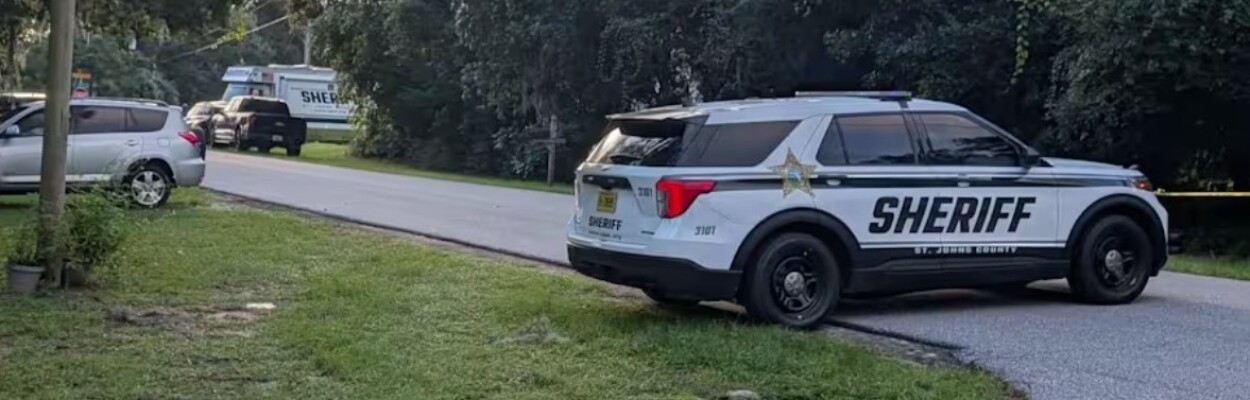 A police car parked where St. Johns County deputies shot a man to death.