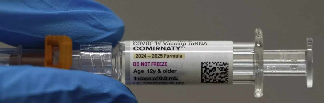 A pharmacist holds a Pfizer and BioNTech COVID-19 vaccine shot
