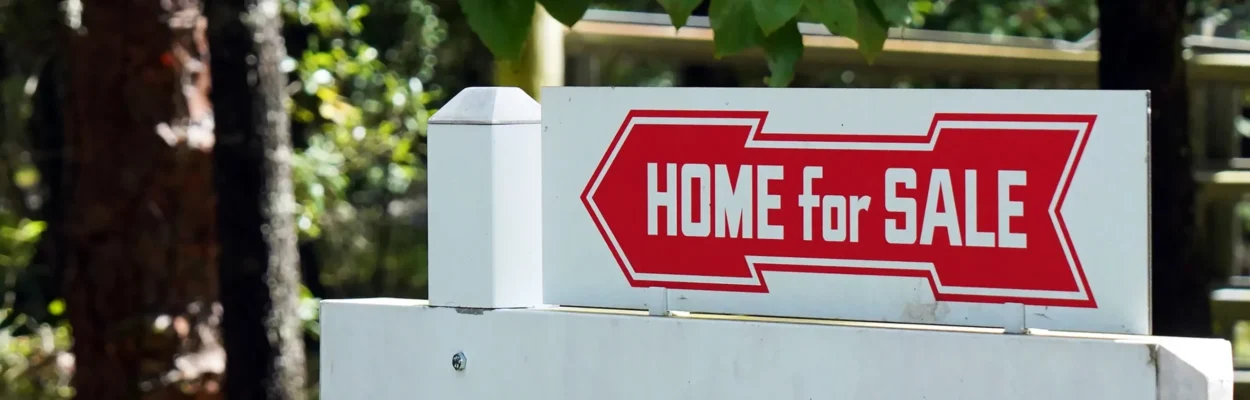 A sign advertising a home for sale during a debate about property taxes