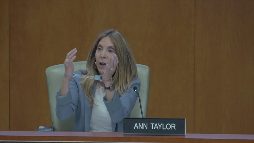 St. Johns County Commissioner Ann Taylor wears handcuffs to illustrate what she says is an attack on home rule.
