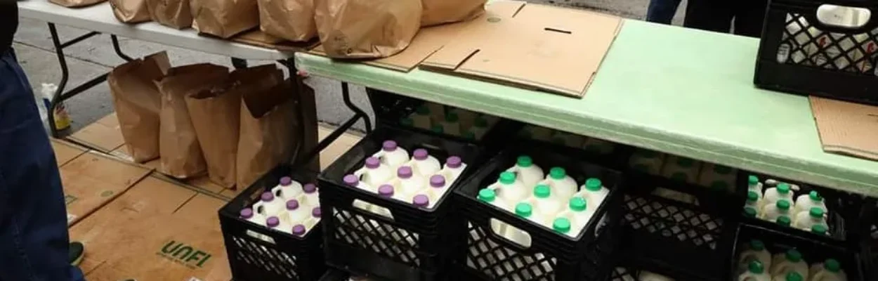Fresh milk and bagged goods sit on a table at the Mandarin Food Bank.