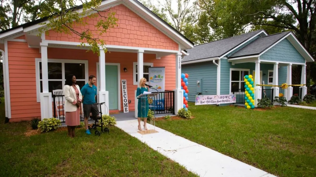 City officials speak in front of one of the new homes in Durkeeville.