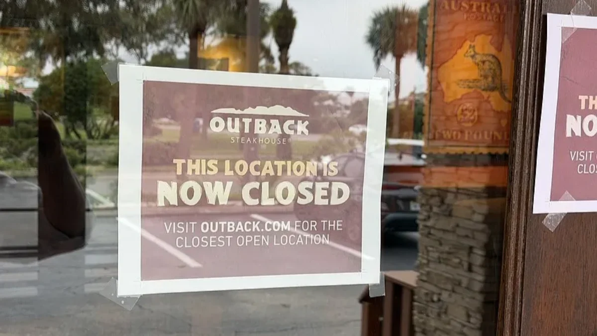 Signs on the door of Outback Steakhouse say it has closed.