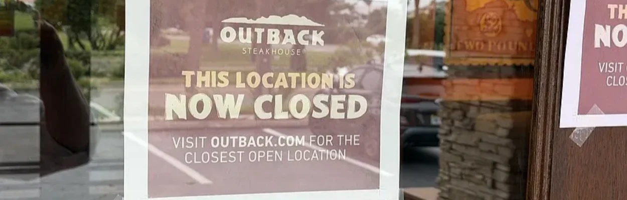 Signs on the door of Outback Steakhouse say it has closed.