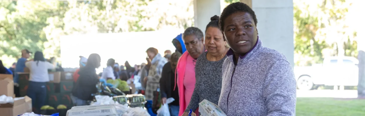 Georgia Patrick, a SNAP recipient, receives food during a distribution drive.