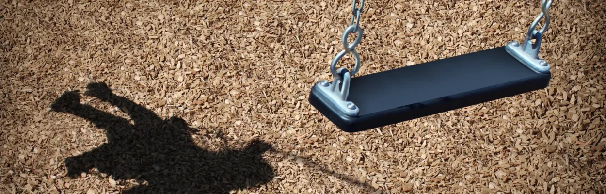 A child's shadow and an empty playground swing symbolize missing or endangered children.