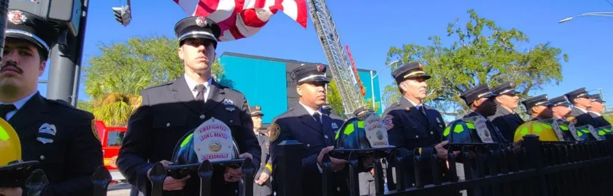 Firefighters stand at Jacksonville’s Fallen Firefighter Memorial.