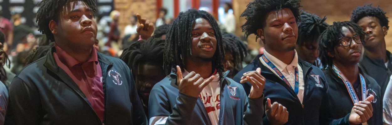Raines football players celebrate at a pep rally.