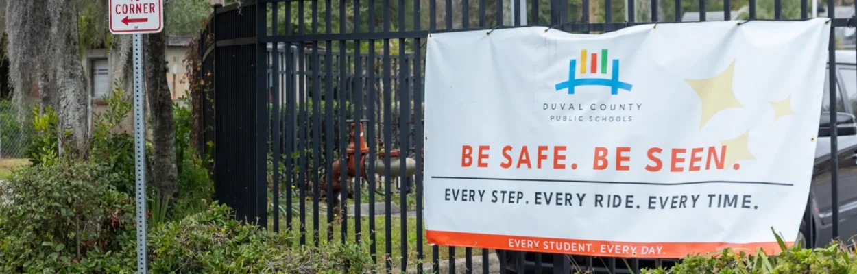 A Duval Schools sign hangs on a fence at Long Branch Elementary, one of the district's planned school closures.