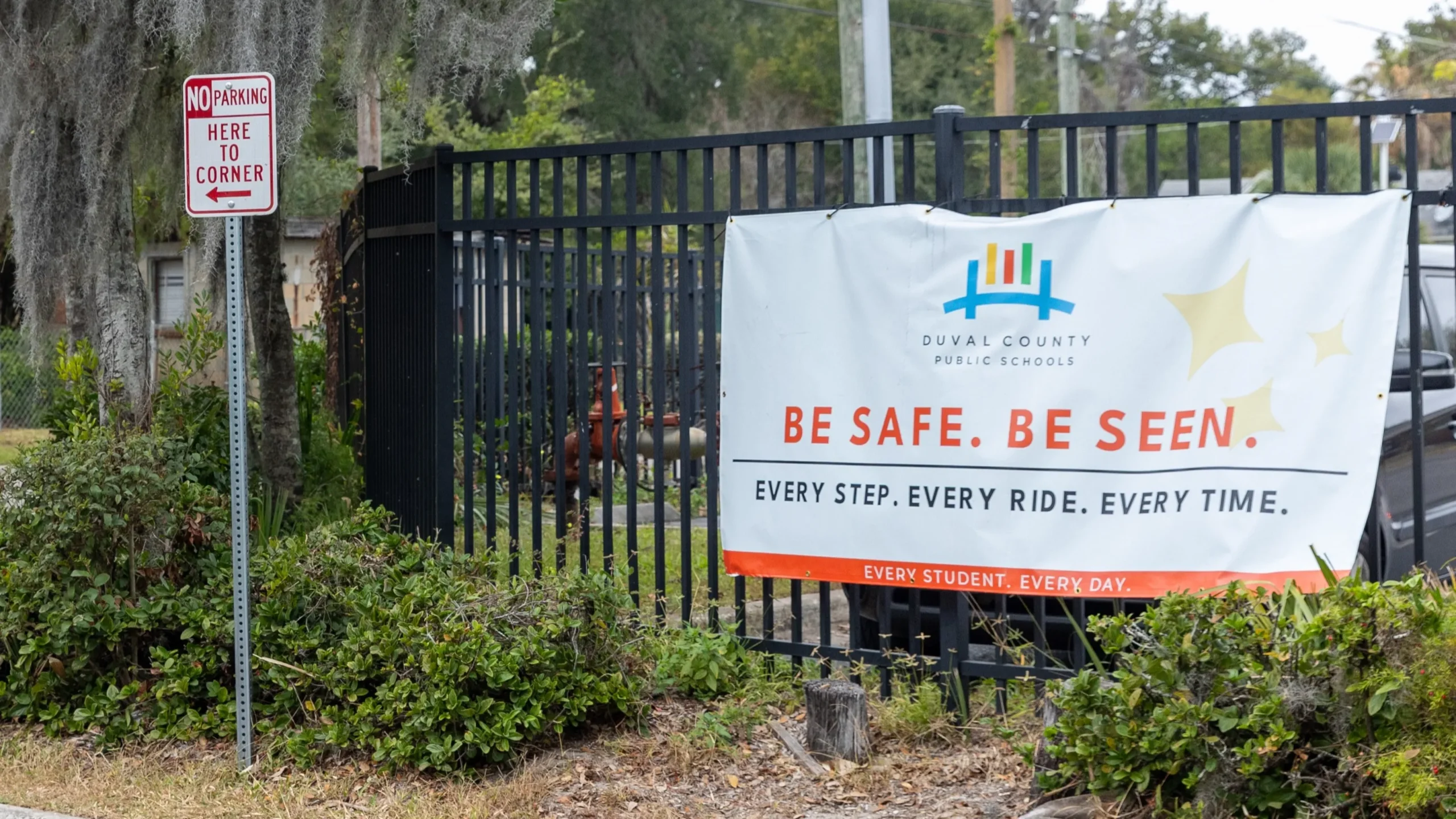 A Duval Schools sign hangs on a fence at Long Branch Elementary, one of the district's planned school closures.