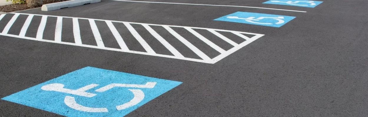 The ground of a parking lot with disabled spaces.