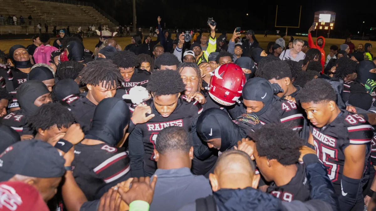The Raines football team huddles after their 28-8 win over Sarasota Booker.