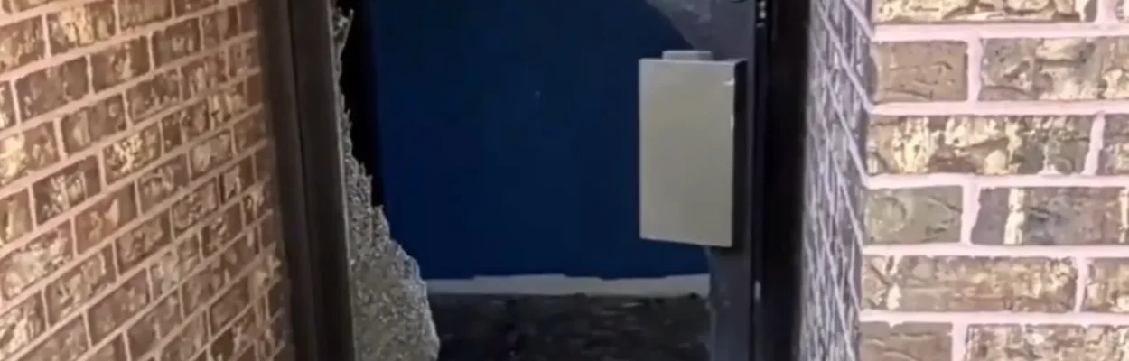 A smashed door at Minds of the Future Academy, where burglars stole $200,000 in technology.