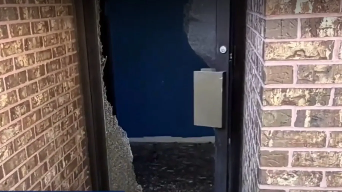 A smashed door at Minds of the Future Academy, where burglars stole $200,000 in technology.