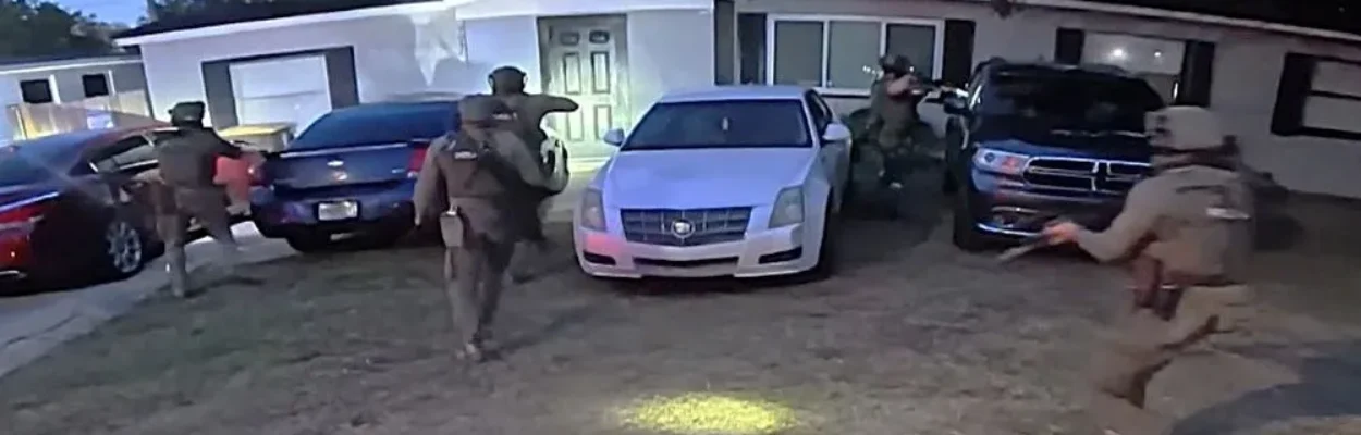 The Narcotics Overdose Death Investigations Unit rushes a house during a drug investigation.