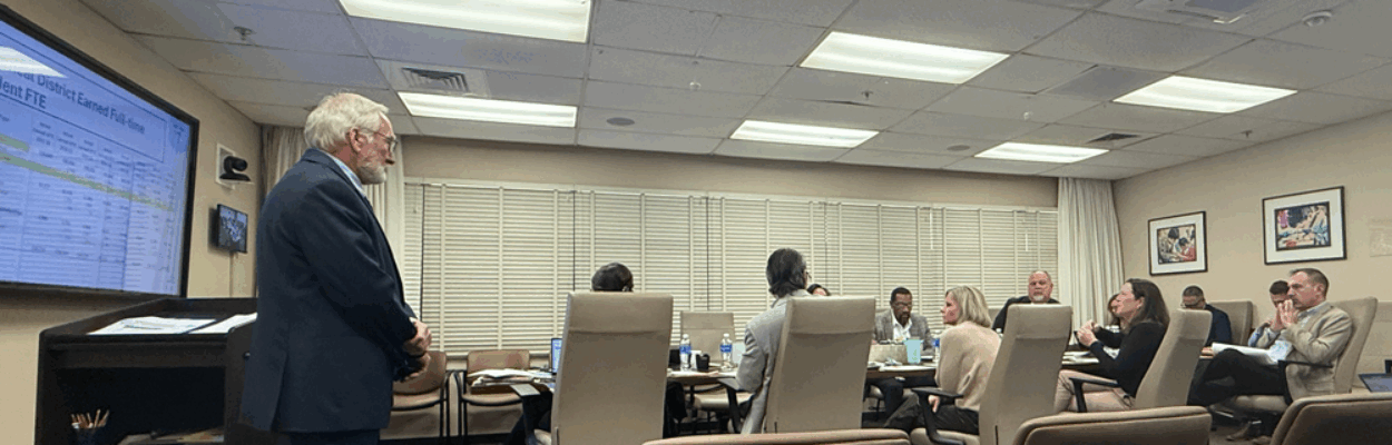 Duval Schools CFO Ron Fagan, left, gives a presentation to school board members about the district's finances on Dec. 8, 2025. | Megan Mallicoat, Jacksonville Today