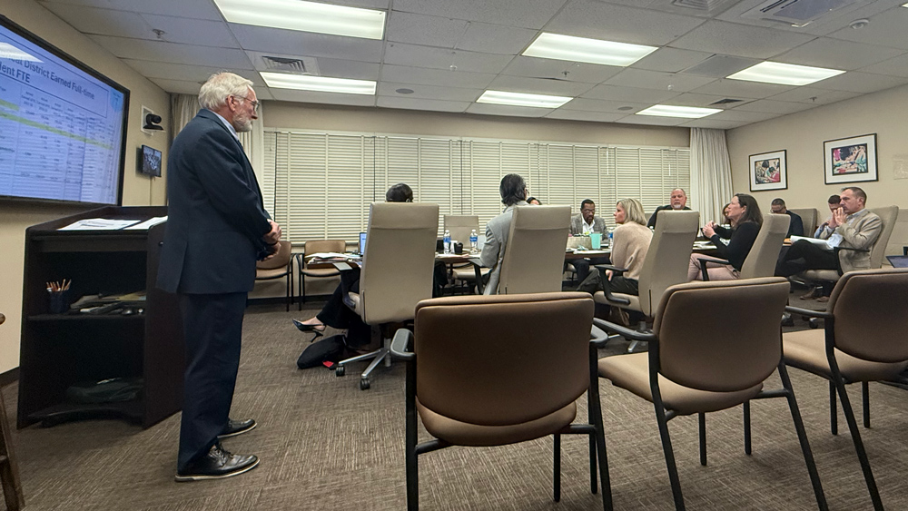 Duval Schools CFO Ron Fagan, left, gives a presentation to school board members about the district's finances on Dec. 8, 2025. | Megan Mallicoat, Jacksonville Today